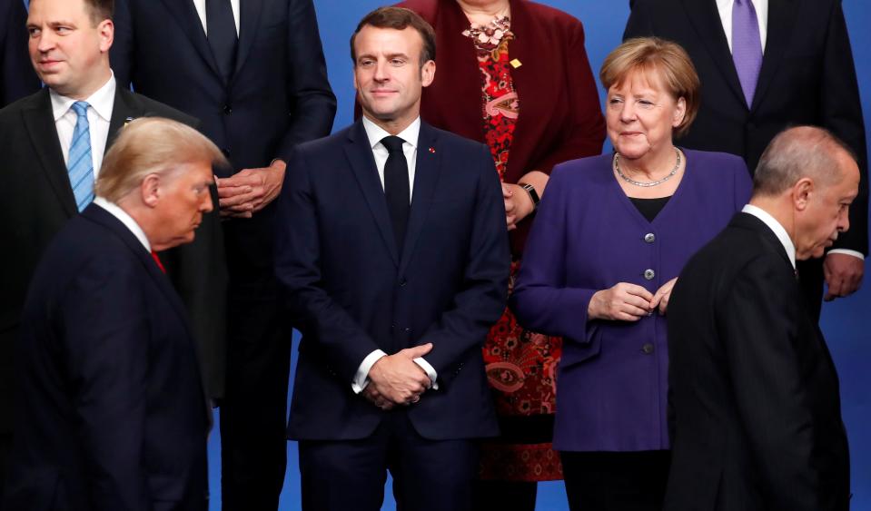 France's President Emmanuel Macron and Germany's Chancellor Angela Merkel look on as U.S. President Donald Trump and Turkey's President Recep Tayyip Erdogan walk during a photo opportunity at the NATO leaders summit in Watford, Britain December 4, 2019. REUTERS/Christian Hartmann/Pool     