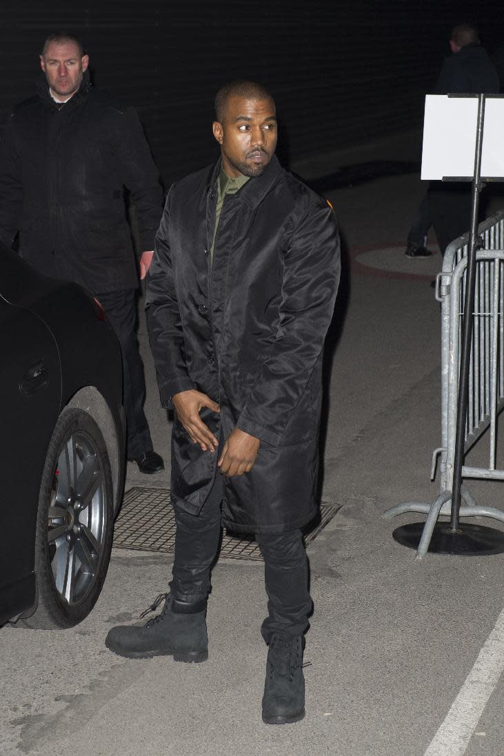 Singer Kanye West arrives at Givenchy's ready-to-wear fall/winter 2014-2015 fashion collection presented in Paris, Sunday, March 2, 2014.(AP Photo/Zacharie Scheurer)