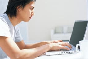 Man using laptop at table