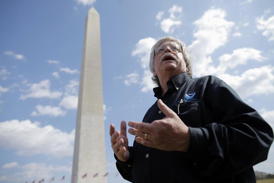 David Doyle, Chief Geodetic Surveyor with the National Oceanic and Atmospheric Administration (NOAA) National Geodetic Survey, is interviewed by the Associated Press on the National Mall with the Washington Monument in the background, Tuesday, March 13, 2012, in Washington. Government surveyors are collecting data around the Washington Monument and other sites on the National Mall that will reveal whether it has sunk or tilted since last year's earthquake. (AP Photo/Charles Dharapak)