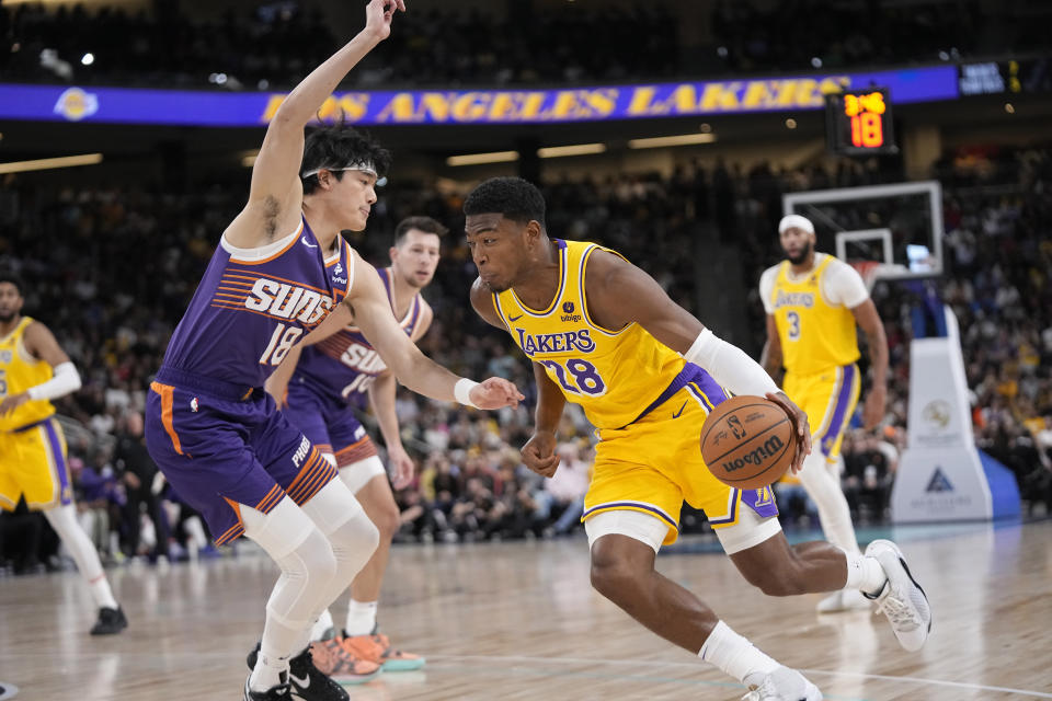 Los Angeles Lakers forward Rui Hachimura, right, drives past Phoenix Suns forward Yuta Watanabe during the first half of an NBA preseason basketball game Thursday, Oct. 19, 2023, in Thousand Palms, Calif. (AP Photo/Mark J. Terrill)