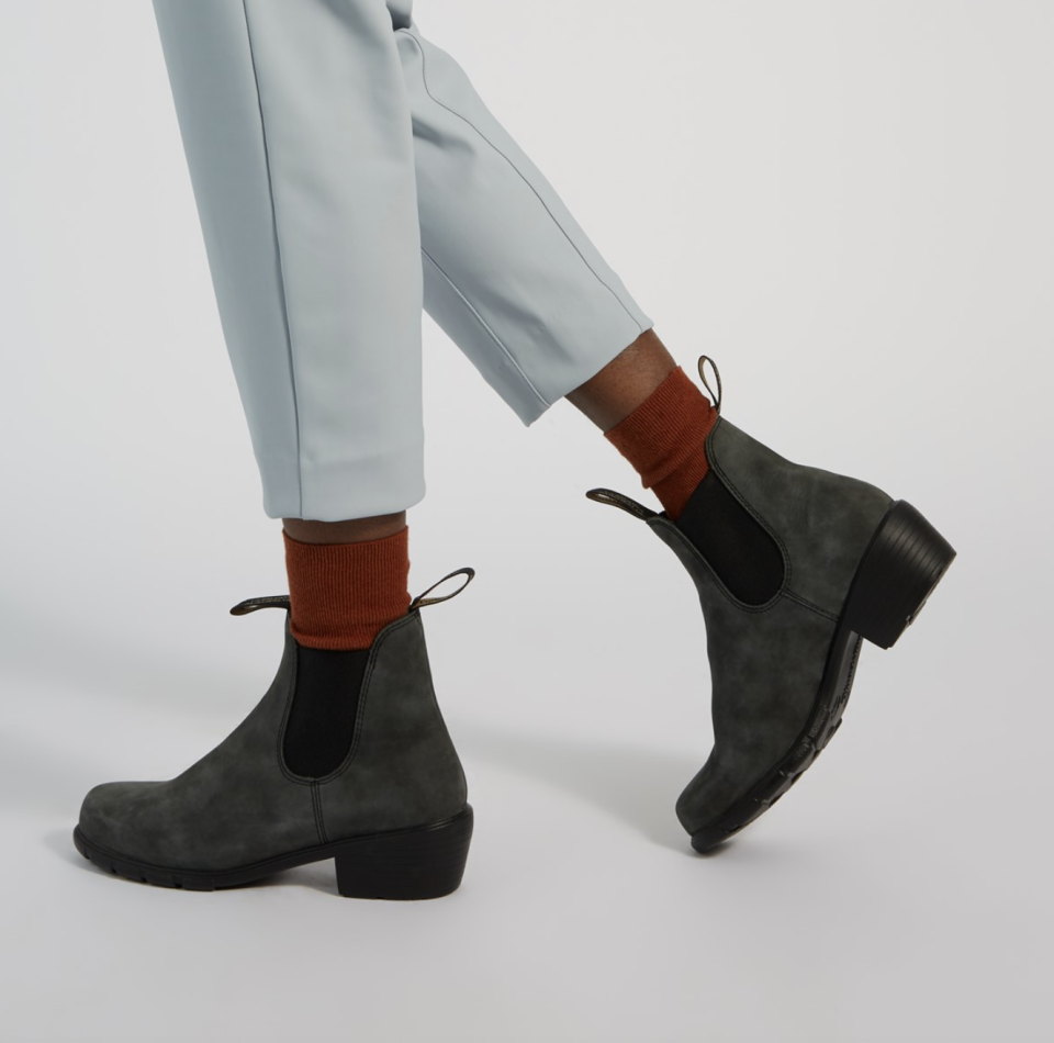 woman in light blue pants, red socks, and Blundstone 2064 Series Heel Boots in Rustic Black (Photo via Little Burgundy Shoes)