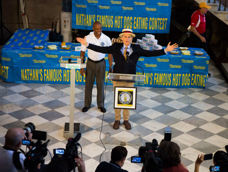 <p>George Shea, center, begins the weight in for the Nathan’s Hotdog Eating Contest Monday, July 3, 2017, in Brooklyn, New York. (AP Photo/Michael Noble) </p>