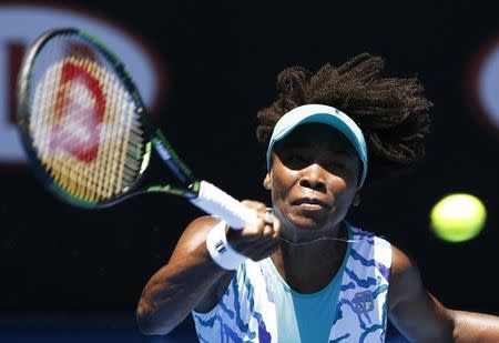 Venus Williams of the U.S. stretches to hit a shot against Lauren Davis of the U.S. during their women's singles second round match at the Australian Open 2015 tennis tournament in Melbourne January 22, 2015. REUTERS/Athit Perawongmetha