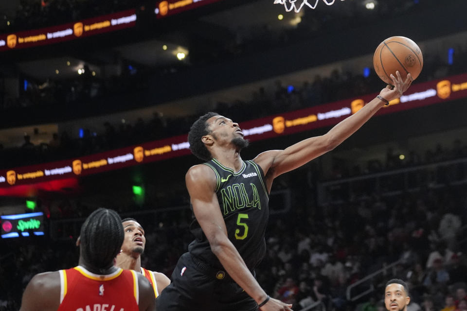 New Orleans Pelicans forward Herbert Jones (5) drives against Atlanta Hawks center Clint Capela (15) during the first half of an NBA basketball game Sunday, March 10, 2024, in Atlanta. (AP Photo/John Bazemore)