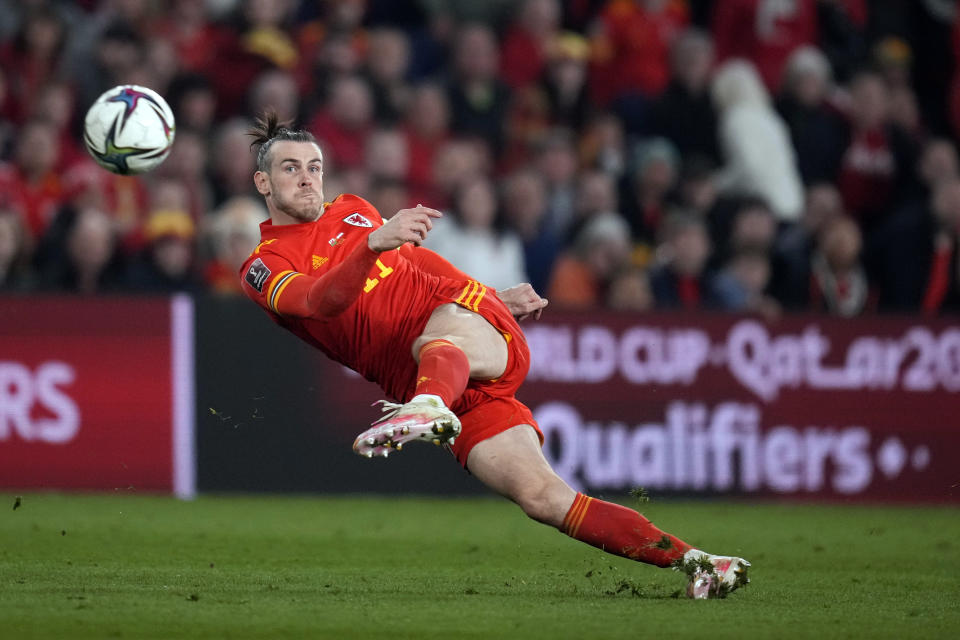 FILE - Wales' Gareth Bale takes a shot during the World Cup 2022 playoff soccer match between Wales and Austria at Cardiff City stadium, in Cardiff, Britain, on March 24, 2022. Los Angeles FC has reached a deal with Bale to move to Major League Soccer after his departure from Real Madrid, a person close to the deal told The Associated Press. The person spoke Saturday, June 25, 2022, on condition of anonymity because the details of the 12-month deal are still being finalized. (AP Photo/Matt Dunham, File)