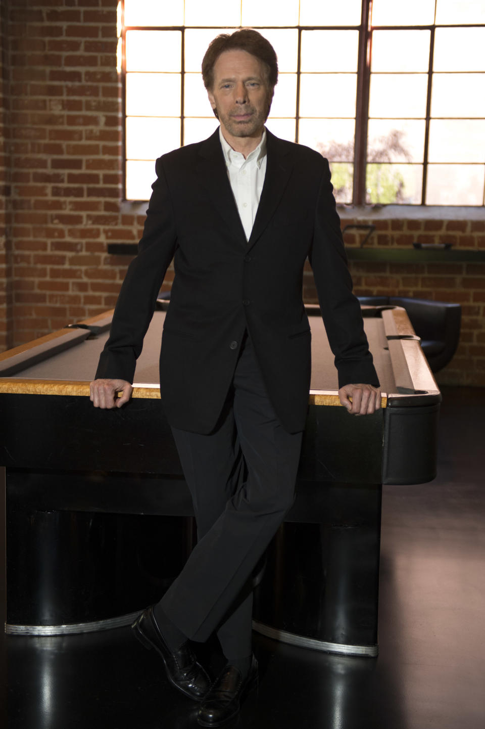 In this Monday, Jan. 13, 2014 photo, Jerry Bruckheimer poses for a portrait at his office in Santa Monica, Calif. After more than two decades with Disney, where he produced the juggernaut “Pirates of the Caribbean” and “National Treasure” film franchises among many box-office hits, Bruckheimer begins a new partnership with Paramount in March 2014. Two new television shows also are actively in the works: A family drama called “Home” and another CSI spinoff, this one focusing on a cyber-psychologist and high-tech crime. (Photo by Jordan Strauss/Invision/AP)