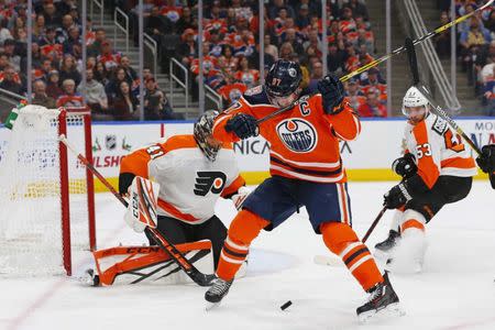 Dec 14, 2018; Edmonton, Alberta, CAN; Edmonton Oilers forward Connor McDavid (97) looks for a loose puck in front of Philadelphia Flyers goaltender Anthony Stolarz (41) during the third period at Rogers Place. Mandatory Credit: Perry Nelson-USA TODAY Sports