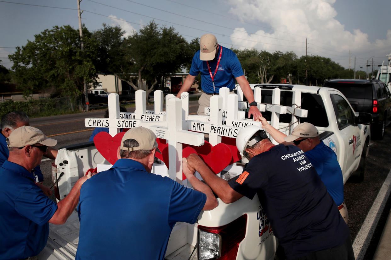 Image: Volunteers pray with crosses to memorialize the victims of a mass shooting at Santa Fe High School in Texas on May 21, 2018. (Scott Olson / Getty Images file)