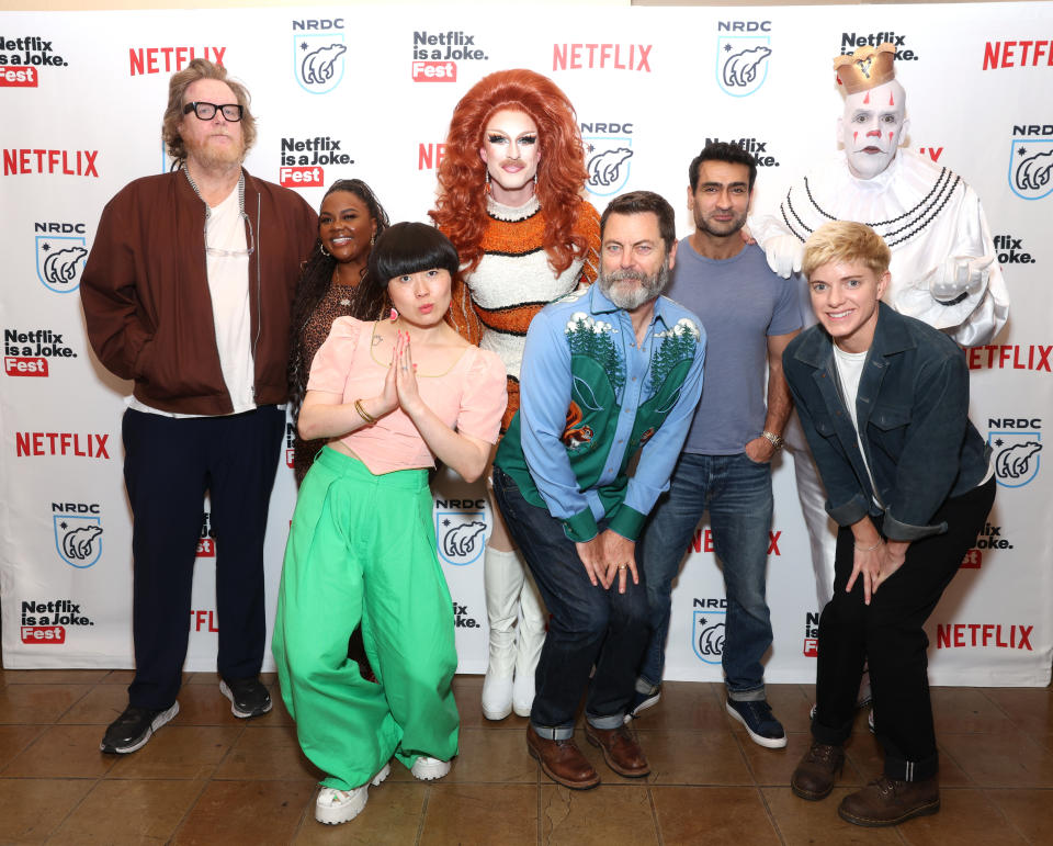 Steve Agee, Nicole Byer, Atsuko Okatsuka, Pattie Gonia, Nick Offerman, Kumail Nanjiani, Mae Martin (front) and Puddles Pity Party in front of a Netflix is a Joke Fest and NRDC backdrop.