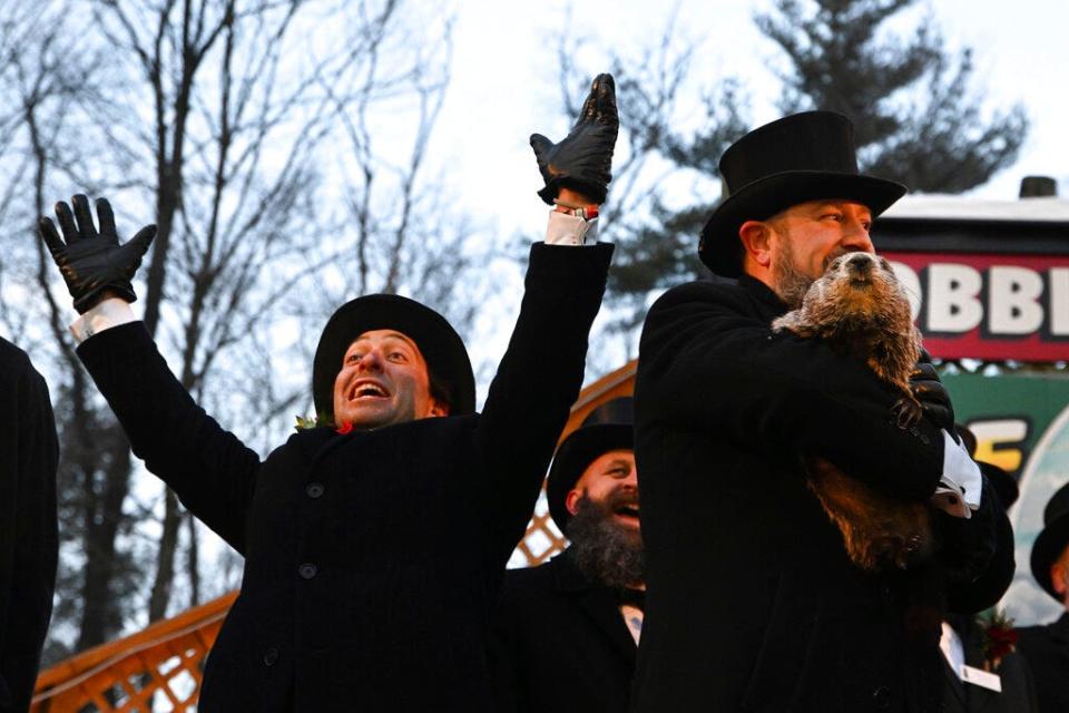 Groundhog Club handler A.J. Dereume holds Punxsutawney Phil, the weather prognosticating groundhog, during the 136th celebration of Groundhog Day on Gobbler's Knob in Punxsutawney, Pa., Wednesday, Feb. 2, 2022. Phil's handlers said that the groundhog has forecast six more weeks of winter. (AP Photo/Barry Reeger)