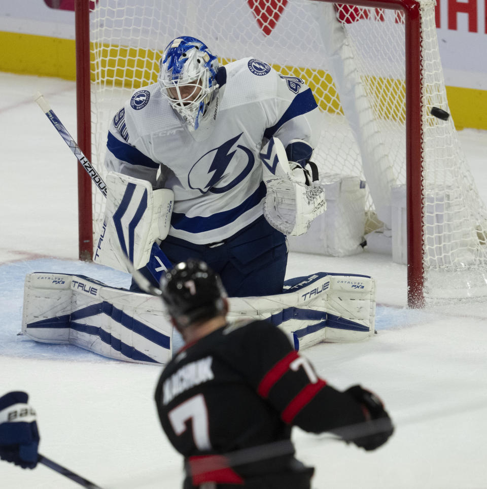 Ottawa Senators left wing Brady Tkachuk fires the puck wide of the net as Tampa Bay Lightning goaltender Matt Tomkins reacts during the second period of an NHL hockey game in Ottawa, Ontario, Sunday, Oct. 15, 2023. (Adrian Wyld/The Canadian Press via AP)
