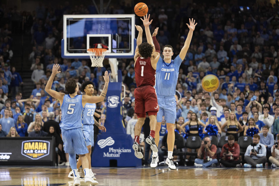 Alabama's Mark Sears (1) attempts a three-pointer against Creighton's Ryan Kalkbrenner (11) in the final seconds of an NCAA college basketball game Saturday, Dec. 16, 2023, in Omaha, Neb. Creighton defeated Alabama 85-82. (AP Photo/Rebecca S. Gratz)