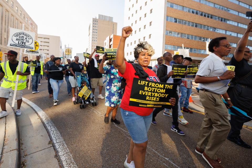 Shannon Easter of Ridgeland, Miss., joins a crowd marching east along Capitol Street in Jackson Monday, en route to a rally in front of the Governor’s Mansion to bring attention to the city’s ongoing water crisis. Easter says she operates a business in Jackson and has a number of family members who live in the capital city.