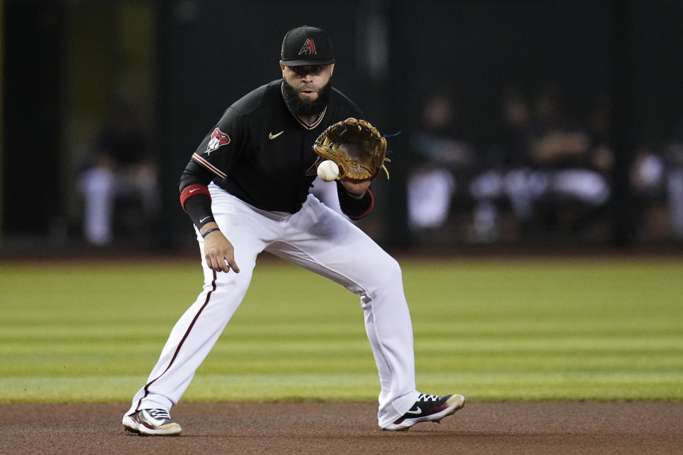 Arizona Diamondbacks third baseman Emmanuel Rivera fields a ground ball hit by St. Louis Cardinals' Andrew Knizner before throwing to second base to start a double play during the fourth inning of a baseball game Monday, July 24, 2023, in Phoenix. (AP Photo/Ross D. Franklin)