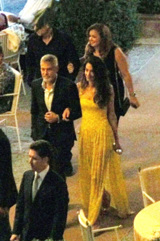 The stylish lawyer wore a vibrant maxi as she enjoyed dinner with the actor and friends in Italy.