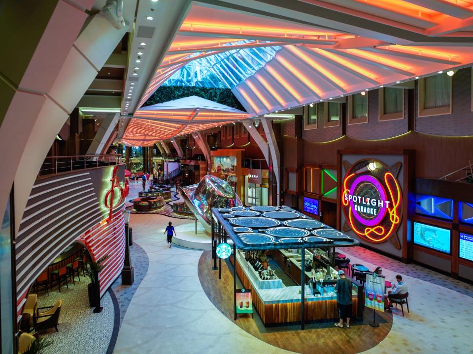 A starbucks stand on an indoor deck on a cruise ship