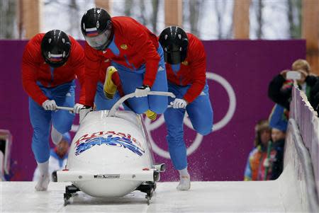 Russia's pilot Alexander Zubkov (front) and his teammates start a run during a four-man bobsleigh training session at the Sanki Sliding Center in Rosa Khutor, during the Sochi 2014 Winter Olympics February 19, 2014. REUTERS/Murad Sezer