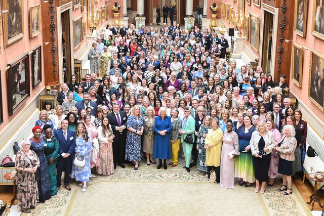 <p>Eamonn M. McCormack - Pool/Getty </p> Queen Camilla (center) with guests at the Buckingham Palace reception to recognize supporters of survivors of sexual assault and mark the relaunch of the Wash Bags project on May 1, 2024.