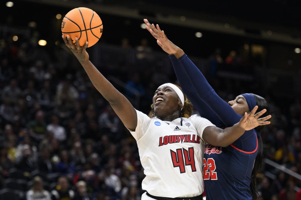 FILE - Louisville forward Olivia Cochran (44) scores a layup as Mississippi forward Tyia Singleton (22) defends during the first half of a Sweet 16 college basketball game in the women's NCAA Tournament in Seattle, Friday, March 24, 2023. Despite this summer’s successful performance, Louisville coach Jeff Walz cautions that cohesion is a work in progress as the new faces blend with seniors Olivia Cochran (8.4 points, 6.5 rebounds per game) and Merissah Russell and sophomores Nyla Harris and Alexia Mobley for the grind.(AP Photo/Caean Couto, File)