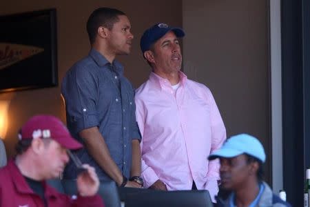 Celebrity comedians Trevor Noah (left) and Jerry Seinfeld (right) watch an opening day game between the New York Mets and the Philadelphia Phillies at Citi Field; April 13, 2015; New York City, NY, USA; Brad Penner-USA TODAY Sports