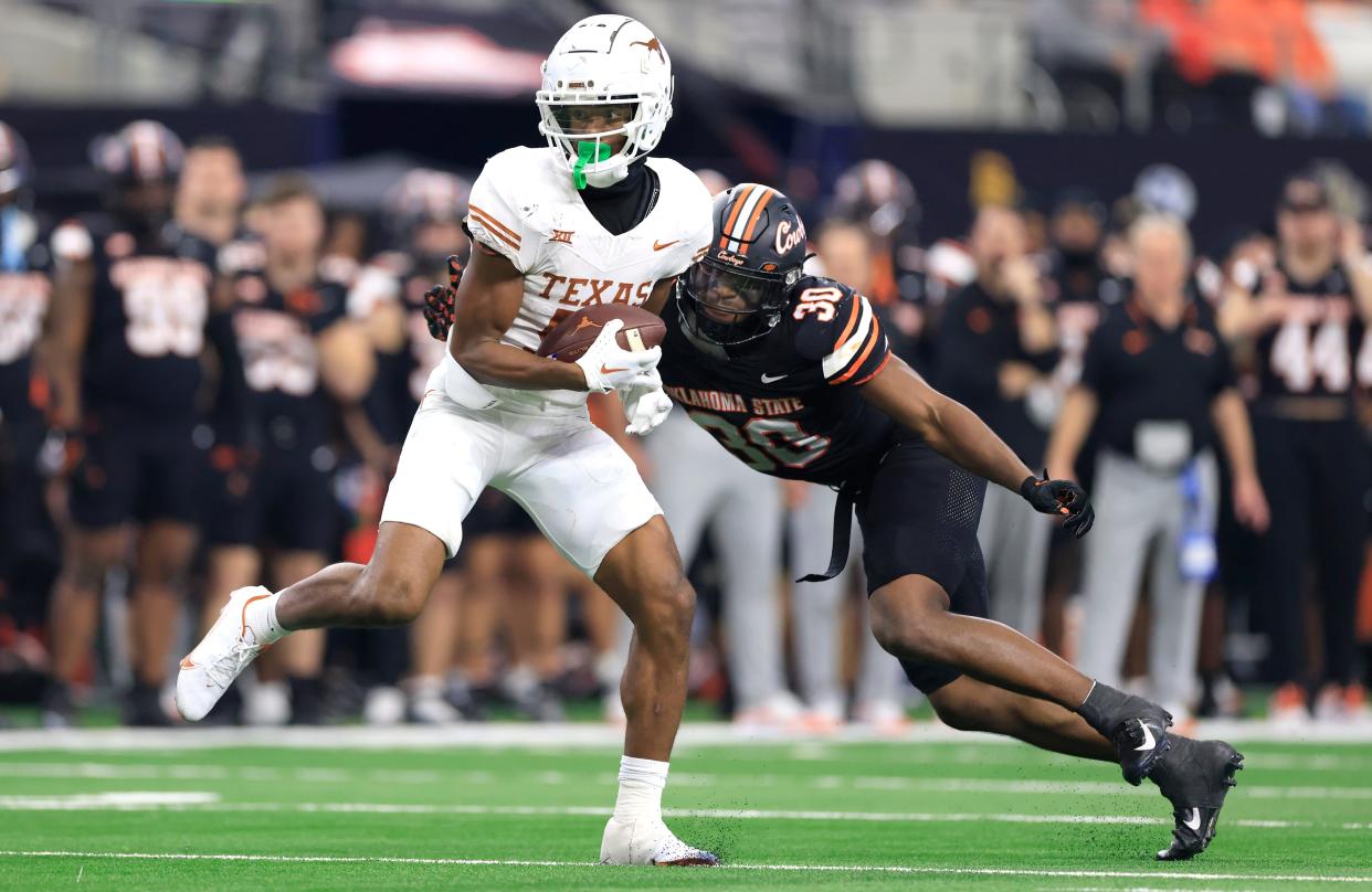 ARLINGTON, TX - DECEMBER 2: Wide receiver Adonai Mitchell #5 of the Texas Longhorns catches a pass against the Oklahoma State Cowboys in the second half of the Big 12 Championship at AT&T Stadium on December 2, 2023 in Arlington, Texas. (Photo by Ron Jenkins/Getty Images)