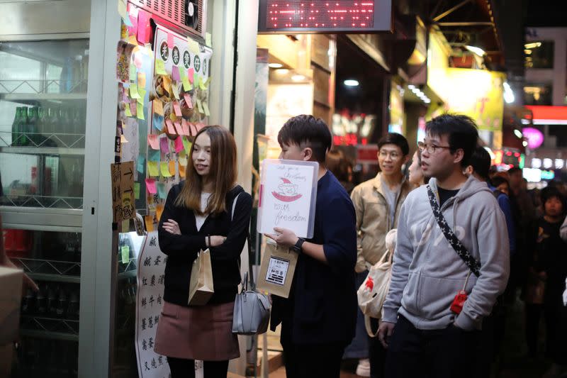 Protesters queue for a free Christmas dinner offered by a local restaurant in Hong Kong