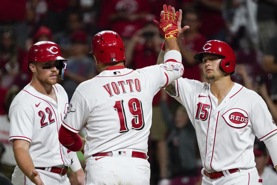 Cincinnati Reds' Joey Votto (19) celebrates with Nick Senzel (15) and Brandon Drury (22) after hitting a three-run home run during the eighth inning of the team's baseball game against the Washington Nationals on Friday, June 3, 2022, in Cincinnati. (AP Photo/Jeff Dean)