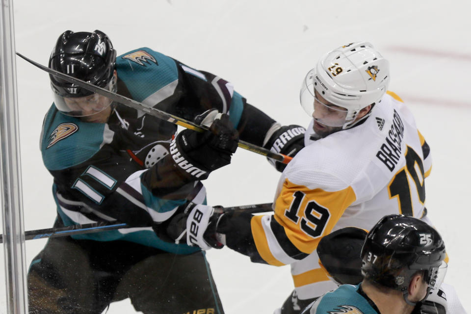 Anaheim Ducks' Daniel Sprong (11) and Pittsburgh Penguins' Derick Brassard (19) battle along the boards during the third period of an NHL hockey game, Monday, Dec. 17, 2018, in Pittsburgh. (AP Photo/Keith Srakocic)