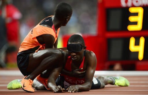 Kenya's Samwel Mushai Kimani (R) is assited by his guide James Boit after winning the men's T11 1500m and breaking the world record at the Paralympic Games at the Olympic Park in east London, England, on September 3, 2012. Athletes at the London Paralympics are on course to break more world records than in Beijing four years ago, the International Paralympic Committee (IPC) said on Tuesday