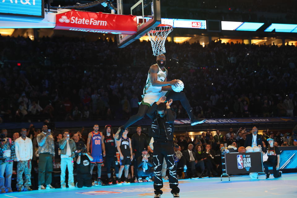 INDIANAPOLIS, INDIANA - FEBRUARY 17: Jaylen Brown #7 of the Boston Celtics dunks the ball over Donovan Mitchell #45 of the Cleveland Cavaliers in the 2024 AT&T Slam Dunk contest during the State Farm All-Star Saturday Night at Lucas Oil Stadium on February 17, 2024 in Indianapolis, Indiana. NOTE TO USER: User expressly acknowledges and agrees that, by downloading and or using this photograph, User is consenting to the terms and conditions of the Getty Images License Agreement. (Photo by Stacy Revere/Getty Images)