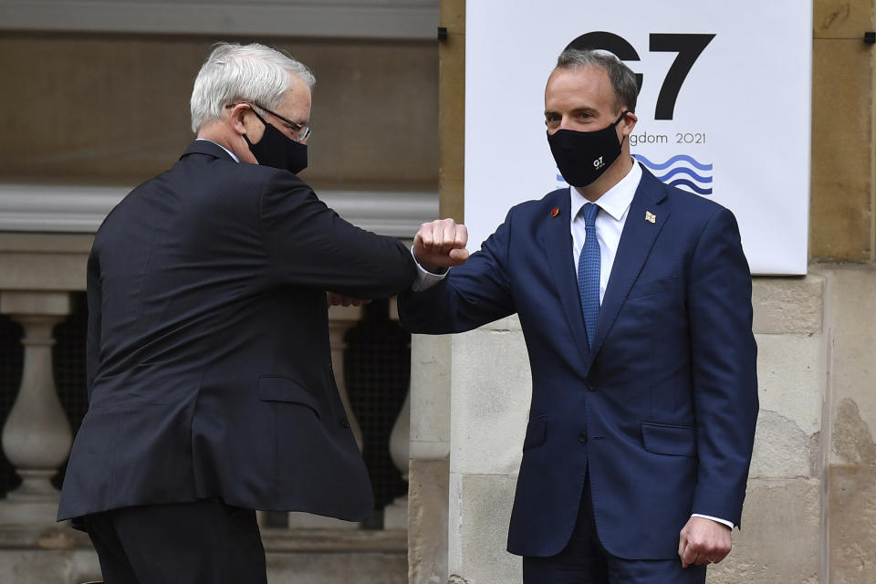 Canada's Foreign Affairs Minister Marc Garneau, left, is greeted by Britain's Foreign Secretary Dominic Raab at the start of the G7 foreign ministers meeting in London Tuesday May 4, 2021. G7 foreign ministers meet in London Tuesday for their first face-to-face talks in more than two years. (Ben Stansall / Pool via AP)