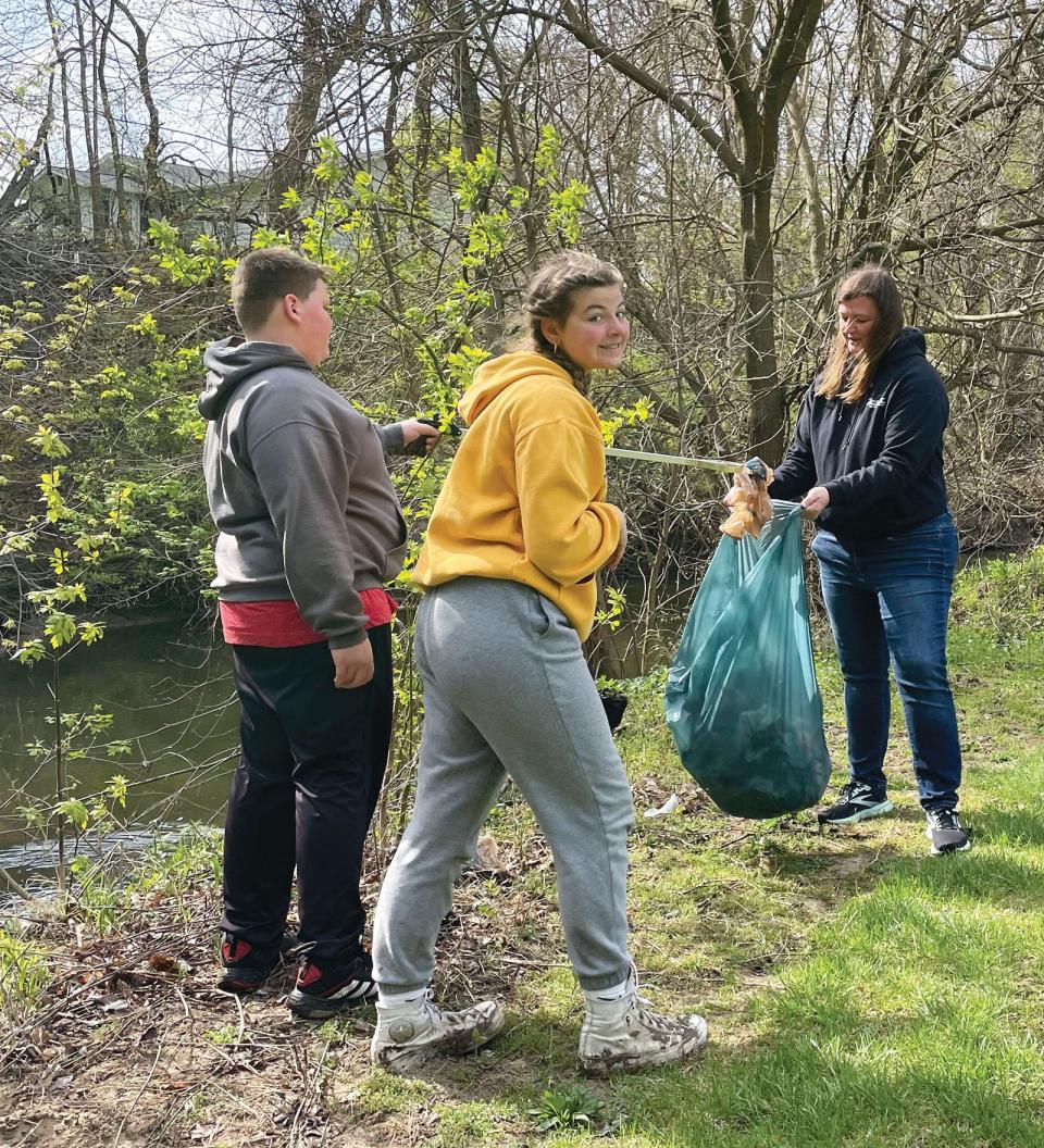 Julie Tison and her children Colt, Emma and Rhett (not pictured) cleaned up litter at Riverside Park along the Kiwanis Trail.