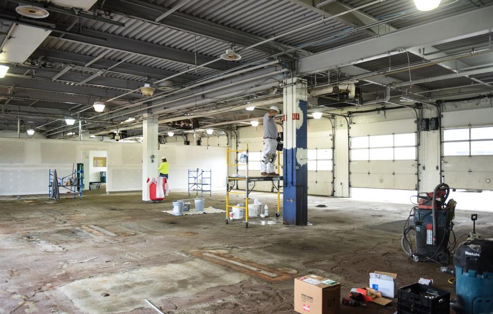 Painters and drywallers work at the former Sears Automotive Center located in Frandor Shopping Center, Friday, May 15, 2020. The former auto-repair bays will be turned into Sparrow Health System drive-thru COVID-19 testing sites.