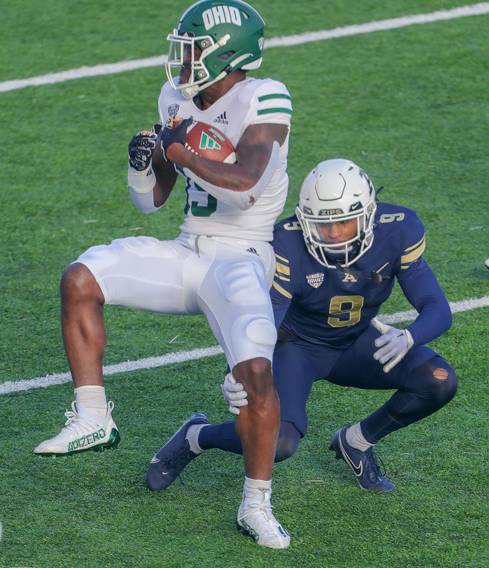 University of Akron defender Judson Tallandier moves in to make the tackle on OU receiver Miles Cross on Friday, Nov. 24, 2023, in Akron, Ohio, at InfoCision Stadium. [Phil Masturzo/ Beacon Journal]