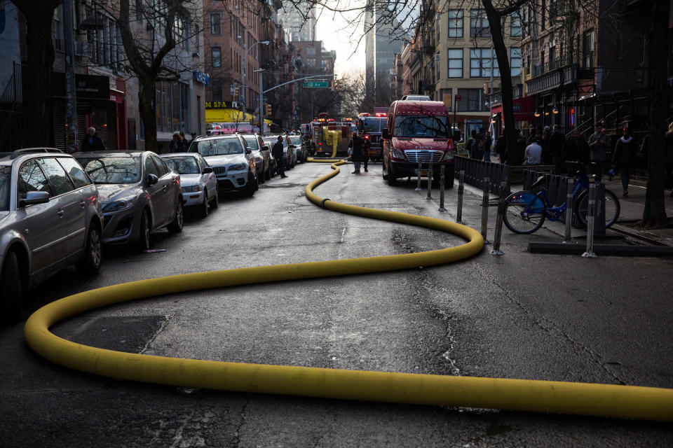 NEW YORK, NY - MARCH 26:  A hose snakes through the street as firefighters battle a blaze caused by an explosion that forced two buildings to collapse on Second Avenue in Manhattan's East Village on March 26, 2015 in New York City.  Officials have reported that at least 12 people were injured but it is unclear if anyone was trapped inside either building.  (Photo by Andrew Burton/Getty Images)