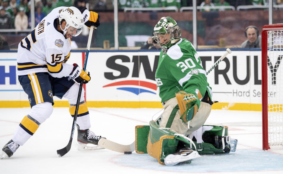 Dallas Stars goaltender Ben Bishop (30) blocks the shot of Nashville Predators right wing Craig Smith (15) in the first period of the NHL Winter Classic hockey game at the Cotton Bowl, Wednesday, Jan. 1, 2020, in Dallas. (AP Photo/Jeffrey McWhorter)