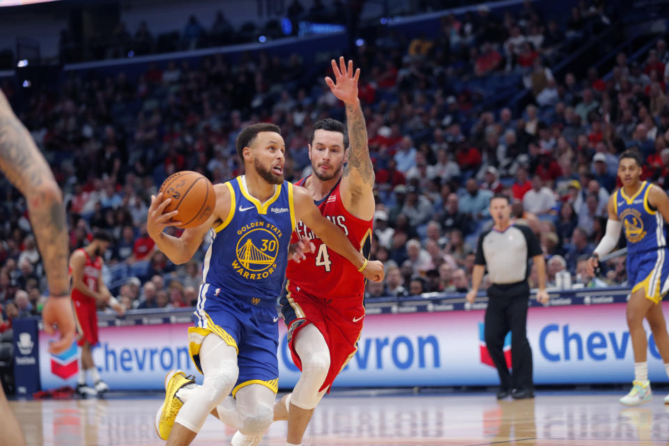 Golden State Warriors guard Stephen Curry (30) drives to the basket against New Orleans Pelicans guard JJ Redick (4) in the first half of an NBA basketball game in New Orleans, Monday, Oct. 28, 2019. (AP Photo/Gerald Herbert)