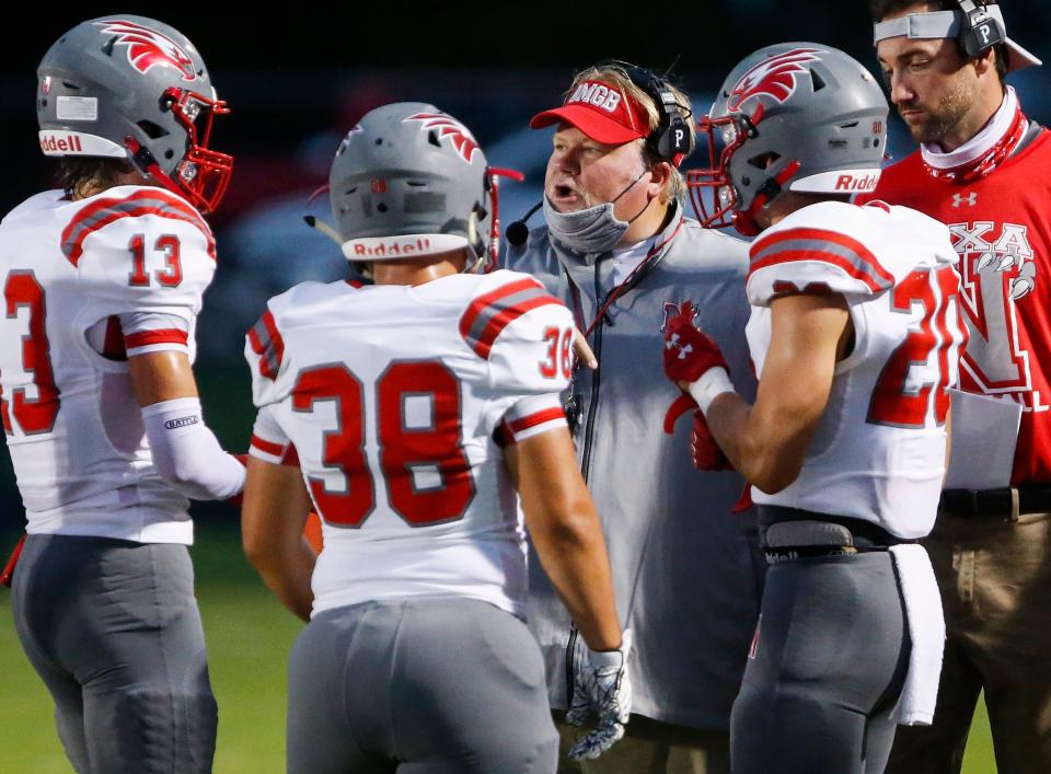 Nixa head coach John Perry talks to his players during the Eagles 42-6 win over Willard at Willard High School on Friday, Sep. 11, 2020.