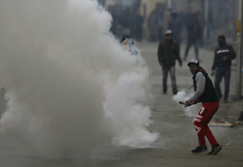 Kashmiri protesters clash with Indian paramilitary soldiers in Srinagar, Indian controlled Kashmir, Sunday, Dec. 16, 2018. A security clampdown and a strike sponsored by separatists fighting against Indian rule shut most of Indian-administered Kashmir on Sunday, a day after chaotic protests and fighting killed seven civilians and four combatants in the disputed region. (AP Photo/Mukhtar Khan)