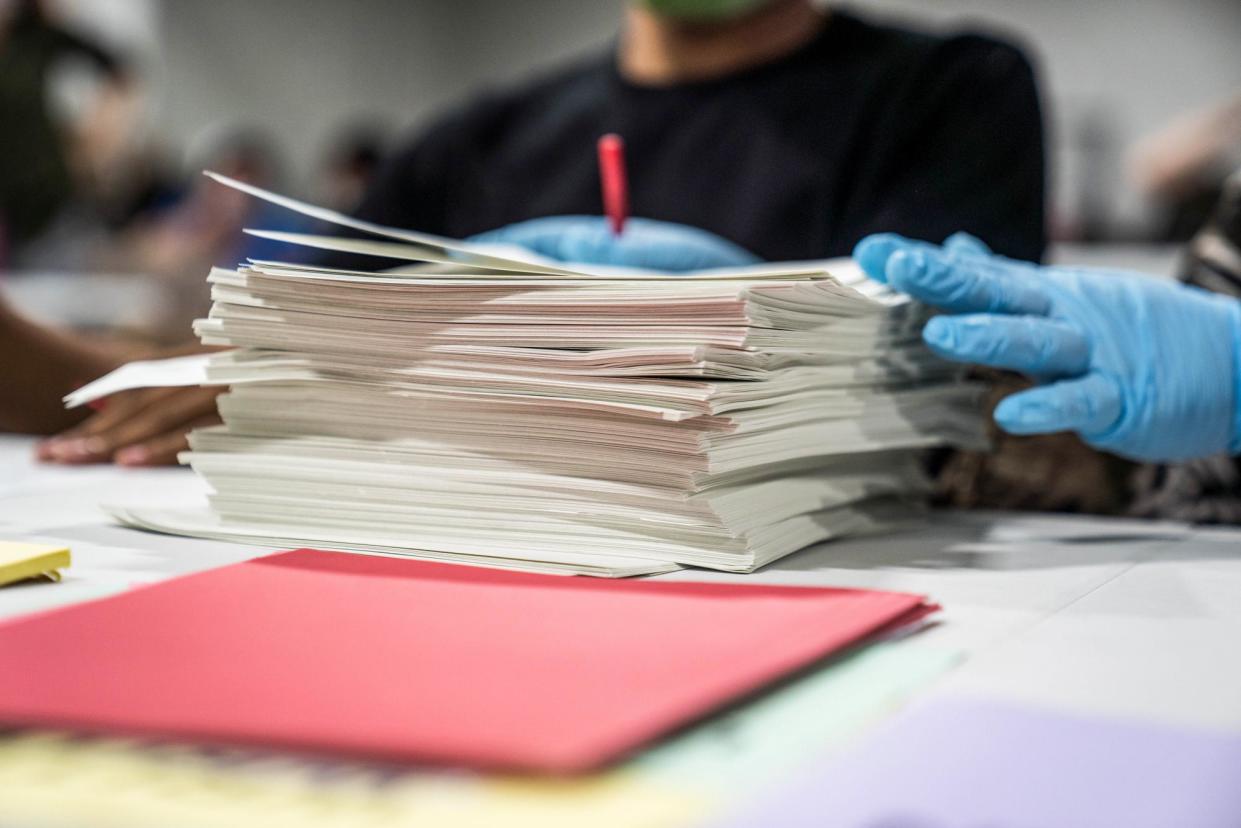 <span>Election workers handle ballots during a recount in Lawrenceville, Georgia, on 16 November 2020.</span><span>Photograph: Megan Varner/Getty Images</span>