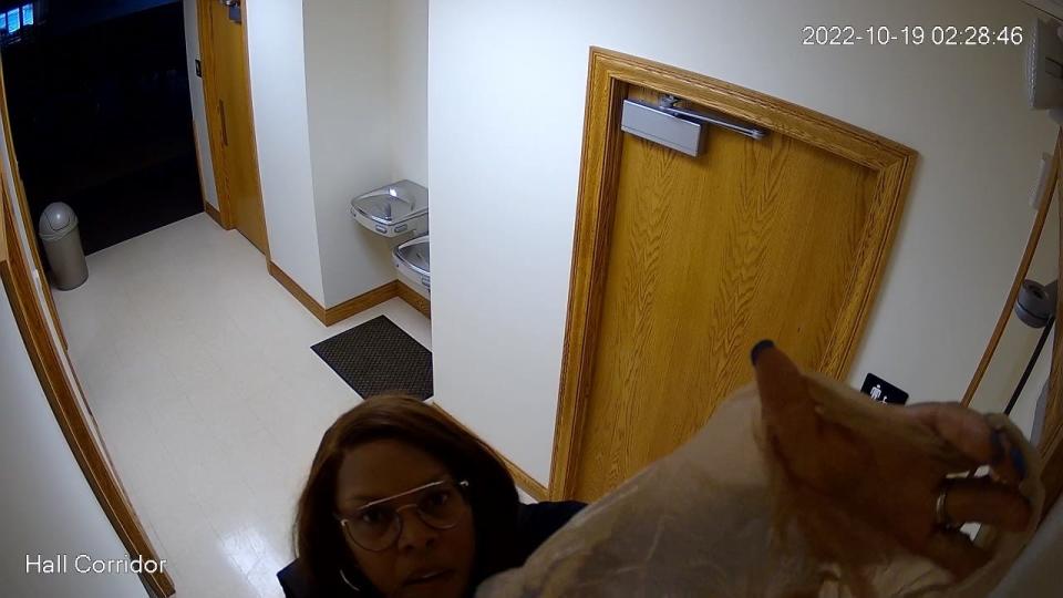 Etna Township Trustee Rozland McKee can be seen covering a security camera with a plastic bag. McKee said she did it because fellow trustee, Mark Evans, was using the system to surveil the building and staff members.