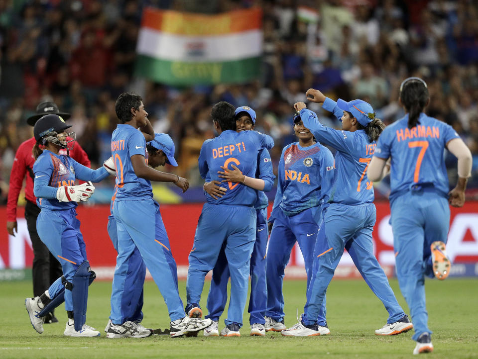 The Indian team celebrate the wicket of Australia's Ashleigh Gardner in the first game of the Women's T20 Cricket World Cup in Sydney, Friday, Feb. 21, 2020. (AP Photo/Rick Rycroft)