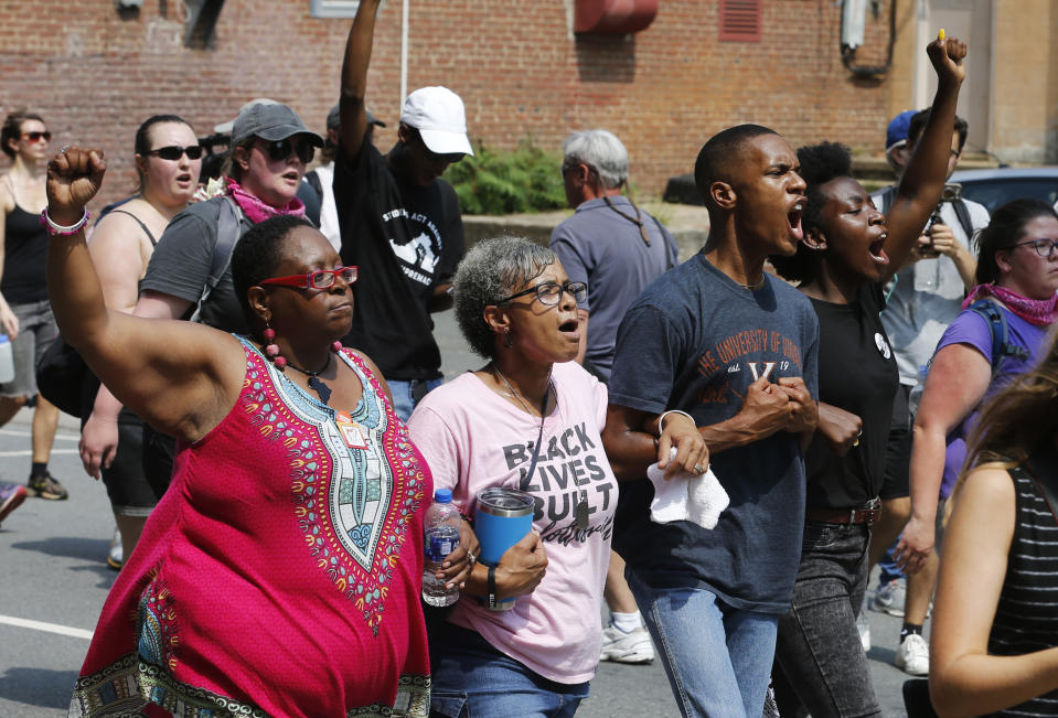 Demonstrators against racism march along city streets as they mark the anniversary of last year's Unite the Right rally in Charlottesville, Va., Sunday, Aug. 12, 2018. (AP Photo/Steve Helber)