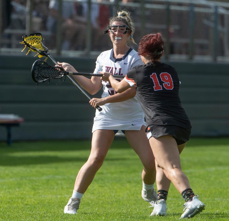 All Sophia DeSibio tries to work in towards goal agains Barnegat Isabel Guro. Wall defeats Barnegat 13-8 in NJSIAA Girls Lacrosse in Wall, NJ on May 20, 2022. 