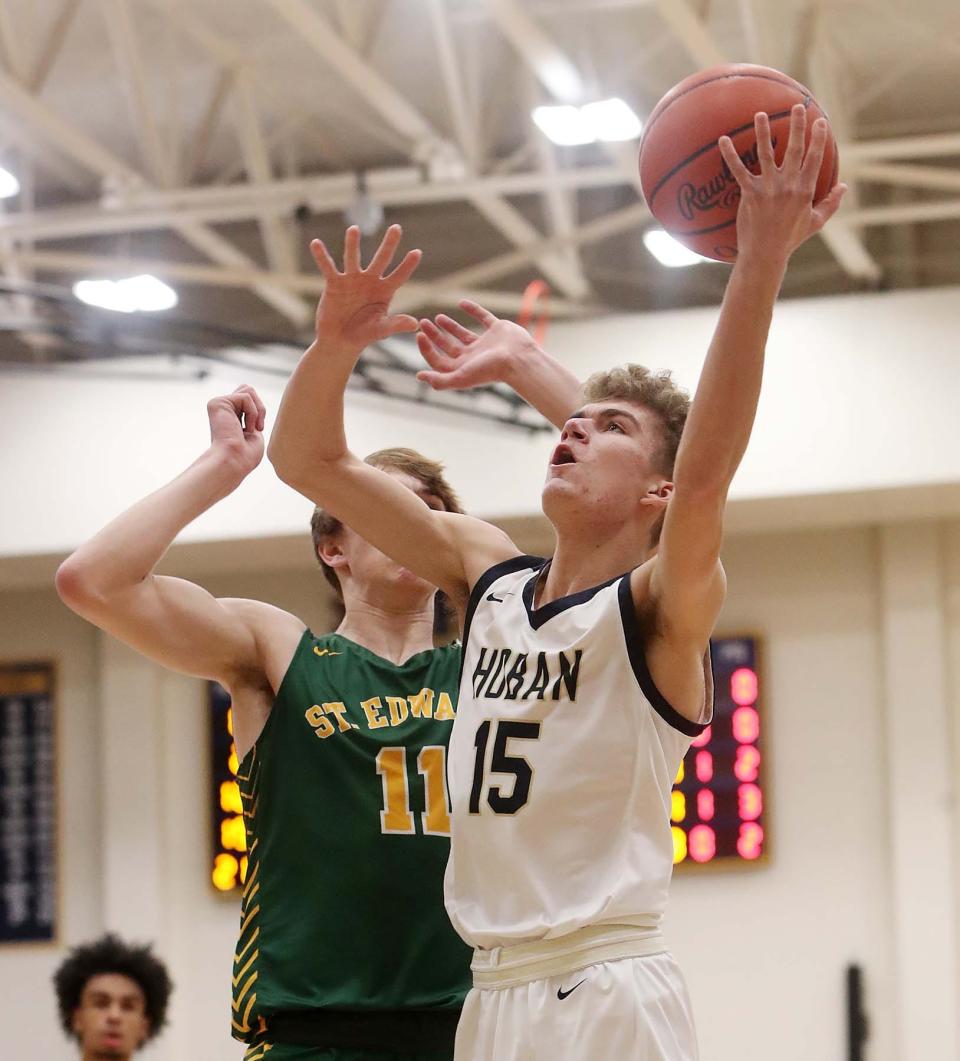 Archbishop Hoban's Logan Vowles attempts to go up for two points over Lakewood St. Edward's Cam Grant during the first quarter of their Division I regional final Saturday at Copley. [Karen Schiely/Beacon Journal]
