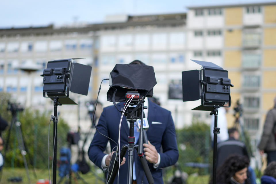 Members of the media set up their gear outside the Agostino Gemelli hospital under the rooms on the top floor normally used when a pope is hospitalised, in Rome, Thursday, March 30, 2023, after The Vatican said Pope Francis has been taken there in the afternoon for some scheduled tests. The Vatican provided no details, including how long the 86-year-old pope would remain at Gemelli University Hospital, where he underwent surgery in 2021. But his audiences through Friday were canceled, raising questions about Francis' participation during the Vatican's Holy Week activities starting Sunday. (AP Photo/Andrew Medichini)