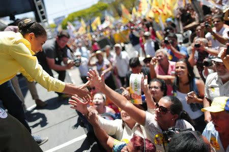 Brazilian Socialist Party (PSB) presidential candidate Marina Silva (L) greets supporters during a campaign rally in the Ceilandia neighbourhood on the outskirts of Brasilia, in this file picture taken September 14, 2014. REUTERS/Ueslei Marcelino/Files