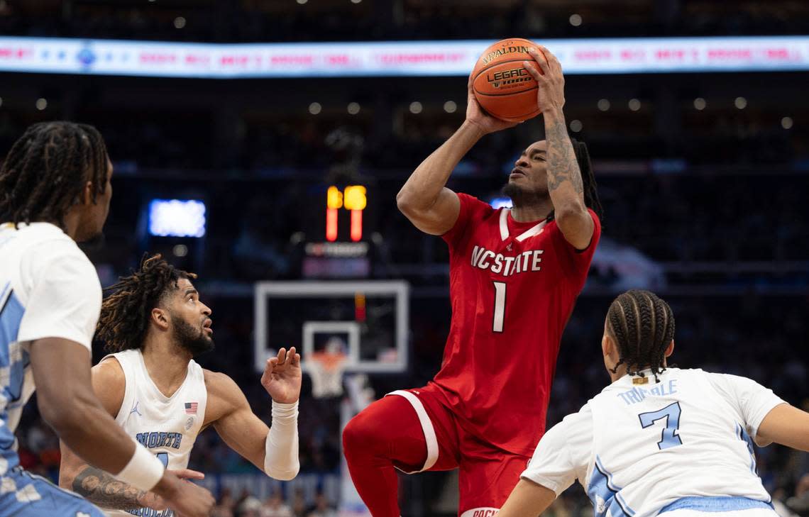 N.C. State’s Jayden Taylor (1) puts up a shot over North Carolina’s R.J. Davis (4) in the first half during the ACC Men’s Basketball Tournament Championship at Capitol One Arena on Saturday, March 16, 2024 in Washington, D.C.