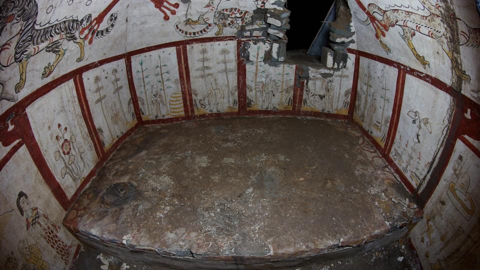  A wide angle shot of the tomb showing intricate paintings on the wall. 